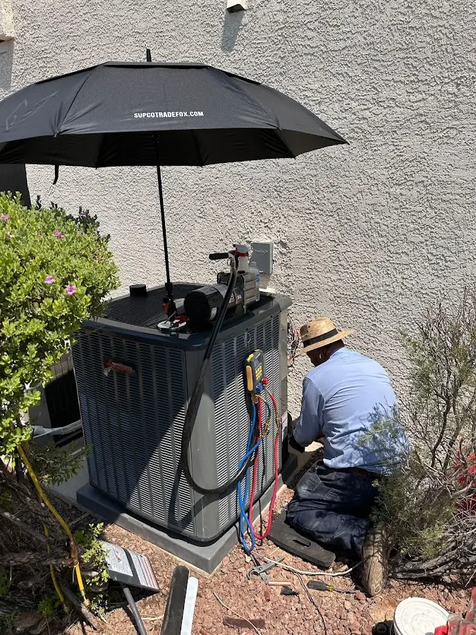 HVAC technician performing outdoor AC maintenance in Norcross